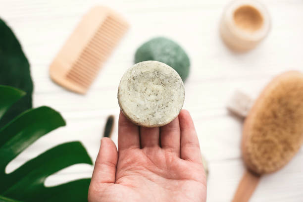 A hand holding a natural deodorant soap