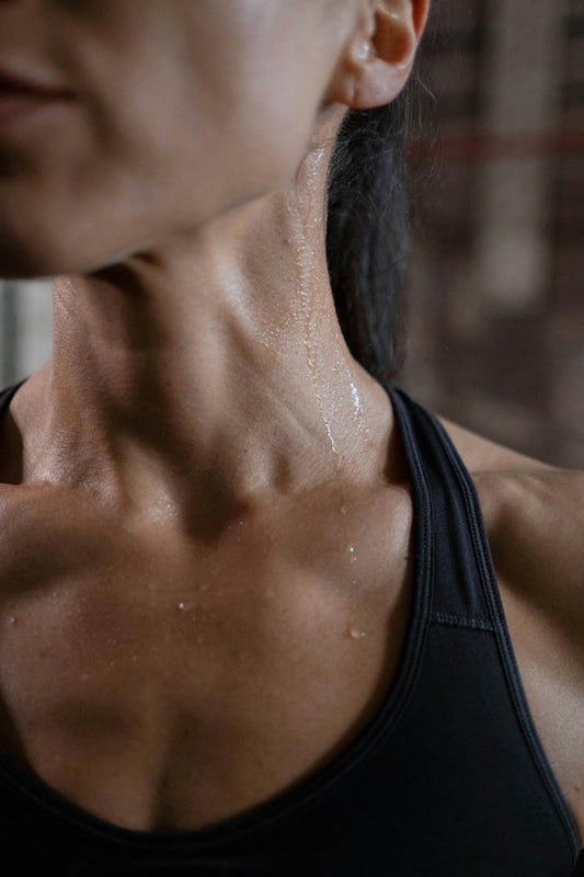 A person’s neck wet from perspiration.