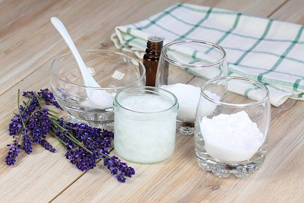 Ingredients for homemade natural deodorant, including baking soda, coconut oil, essential oil, and lavender 