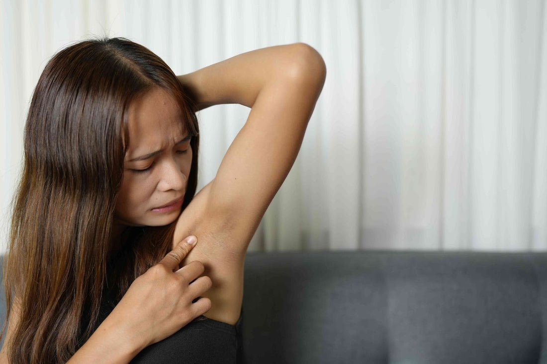 A woman staring into their armpit.