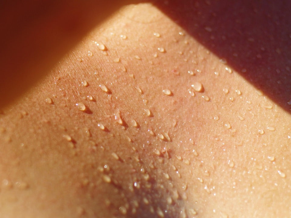 A person’s chest wet with perspiration.